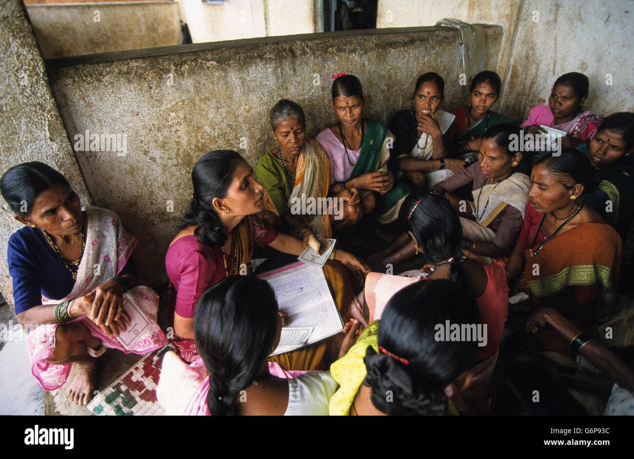 A FreshKart field officer meeting with a women's lending group